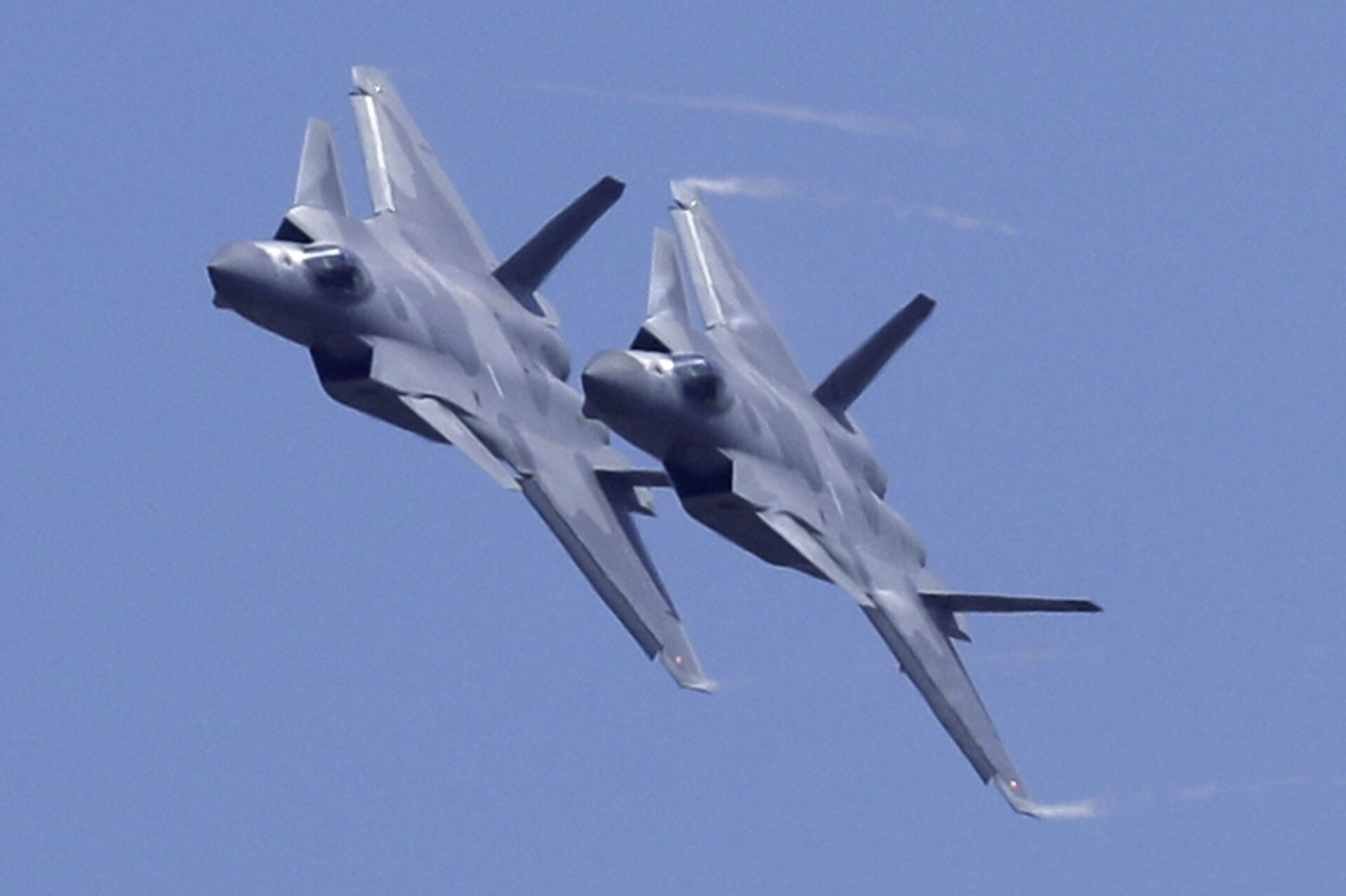 Two J-20 stealth fighter jets of the Chinese People's Liberation Army (PLA) Air Force performs during the 12th China International Aviation and Aerospace Exhibition, also known as Airshow China 2018, Tuesday, Nov. 6, 2018, in Zhuhai city, south China's Guangdong province - Sputnik India, 1920, 20.02.2024