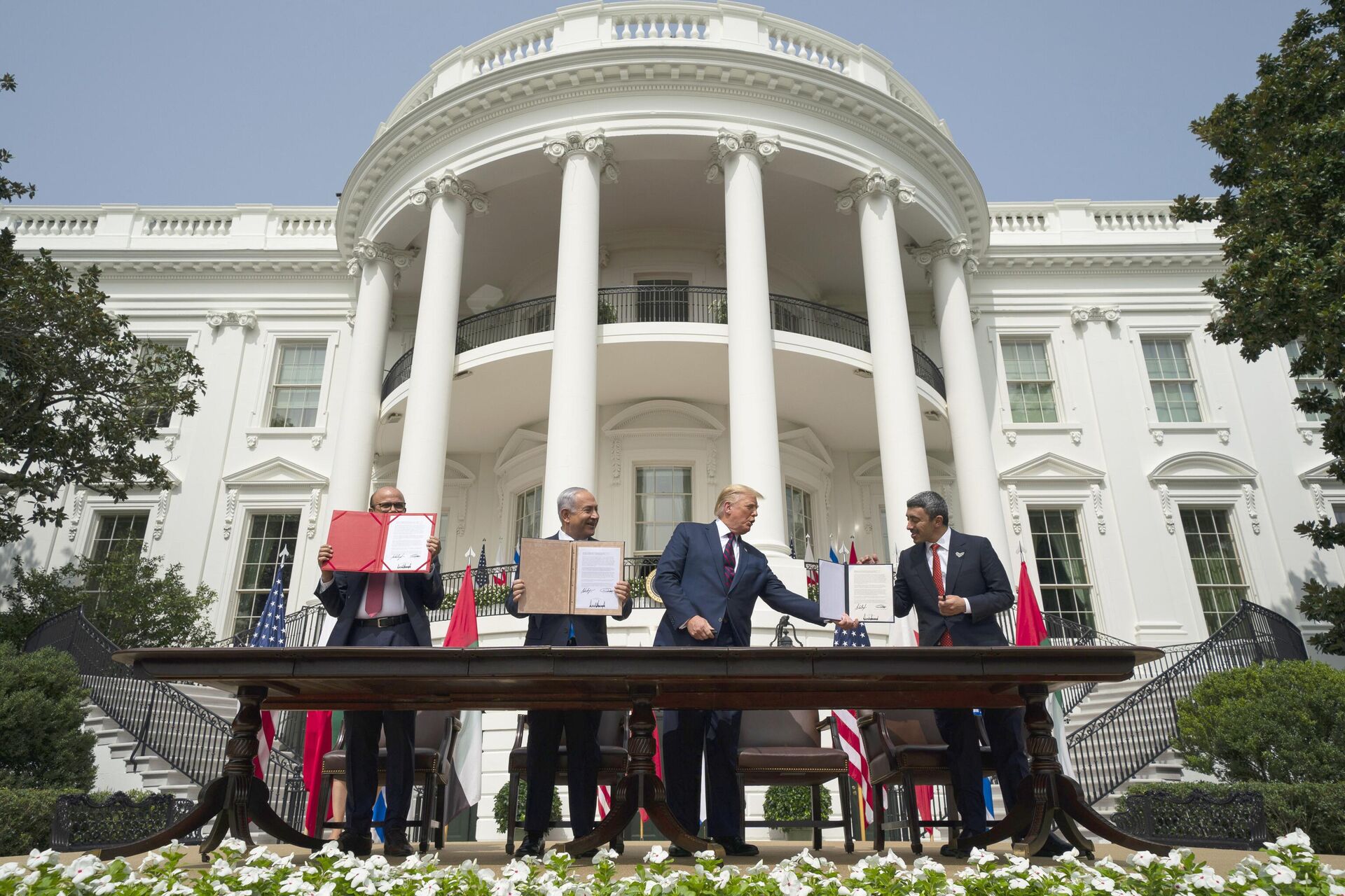 President Donald Trump, center, with, from left, Bahrain Foreign Minister Khalid bin Ahmed Al Khalifa, Israeli Prime Minister Benjamin Netanyahu, and United Arab Emirates Foreign Minister Abdullah bin Zayed al-Nahyan, during the Abraham Accords signing ceremony on the South Lawn of the White House, Tuesday, Sept. 15, 2020, in Washington. - Sputnik India, 1920, 10.11.2023