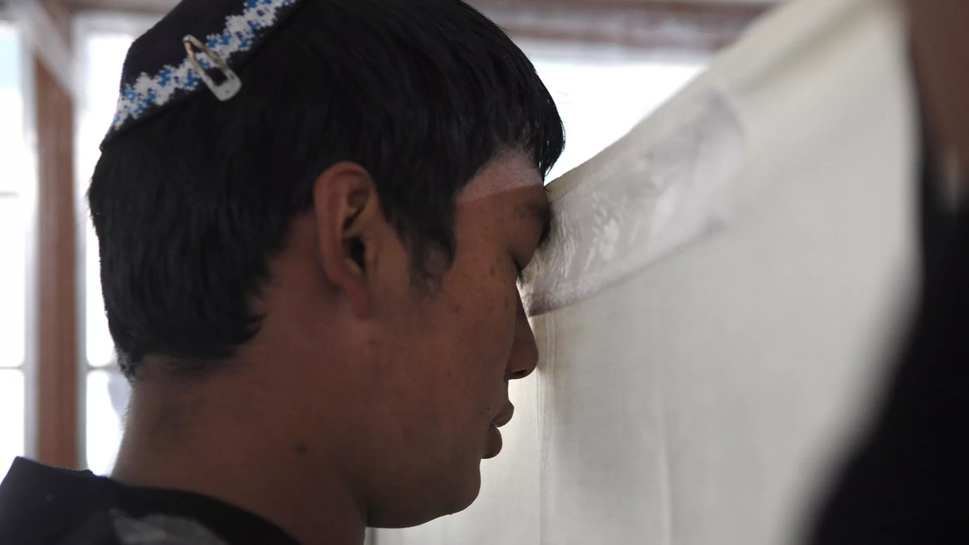 A Bnei Menashe Jewish community boy prays in a Synagogue, during a prayer ceremony