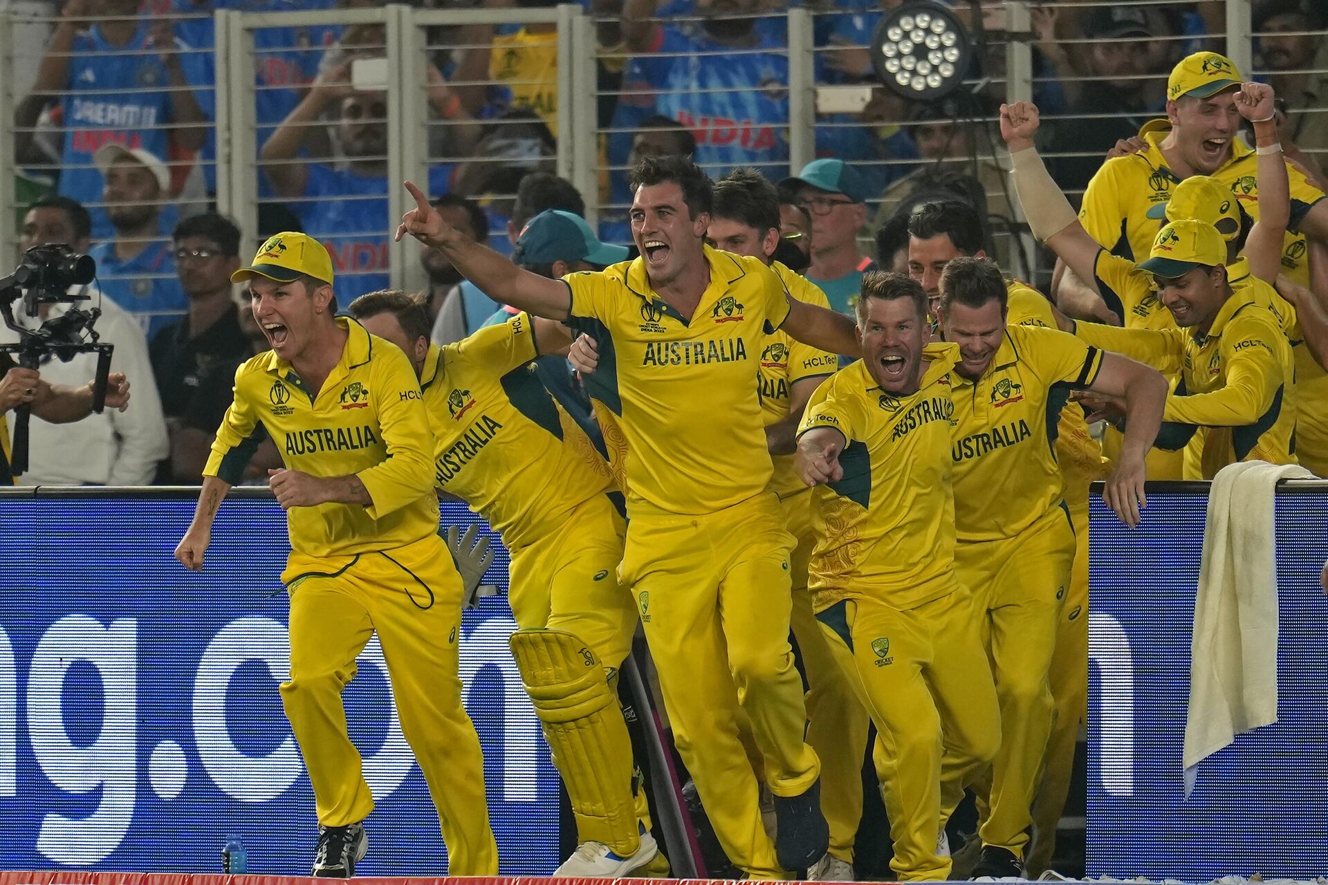 Australia's captain Pat Cummins, center, and teammates run to celebrate after their win in the ICC Men's Cricket World Cup final match against India in Ahmedabad - Sputnik India, 1920, 20.11.2023