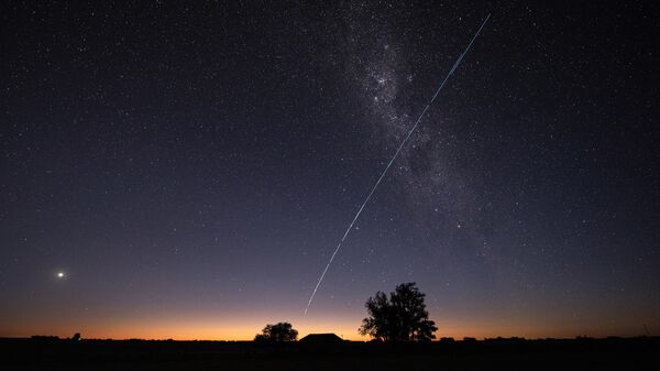 This long-exposure image shows a trail of a group of SpaceX's Starlink G6-27 satellites passing over Uruguay, with part of the Milky Way and planet Venus (L) in the frame, as seen from the countryside some 185 km north of Montevideo near Capilla del Sauce, Florida Department, at twilight early on November 12, 2023. - Sputnik भारत