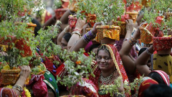 Indian Hindu devotees carry Tulsi or Tulasi plants (Ocimum tenuiflorum) through a religious procession during the holy month of Karthik in Hyderabad, India, Wednesday, Nov. 28, 2012. - Sputnik India