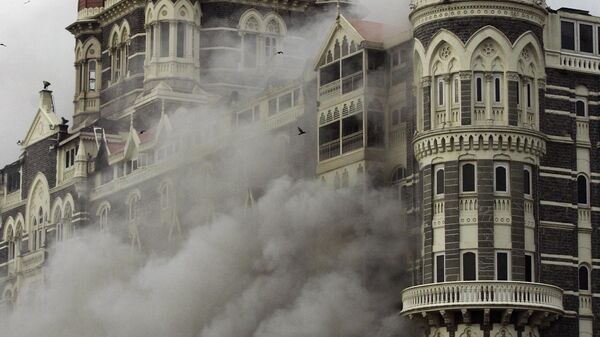 In this Nov. 29, 2008 file photo, smoke emits from the Taj Mahal Hotel in Mumbai, India. - Sputnik भारत