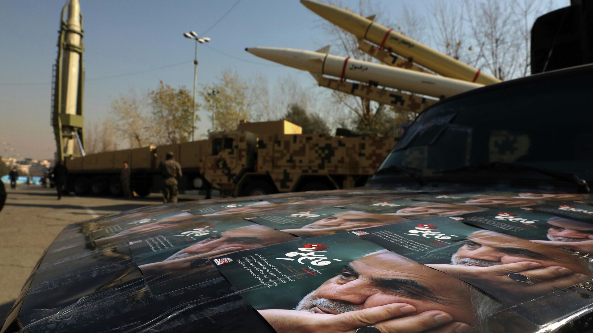Posters of Iranian Gen. Qassem Soleimani, who was killed in Iraq in a U.S. drone attack in Jan. 3, 2020, are seen in front of Qiam, background left, Zolfaghar, top right, and Dezful missiles displayed in a missile capabilities exhibition by the paramilitary Revolutionary Guard a day prior to second anniversary of Iran's missile strike on U.S. bases in Iraq in retaliation for killing Gen. Soleimani, at Imam Khomeini grand mosque, in Tehran, Iran, Friday, Jan. 7, 2022. Iran put three ballistic missiles on display on Friday, as talks in Vienna aimed at reviving Tehran's nuclear deal with world powers flounder.  - Sputnik भारत, 1920, 06.12.2023