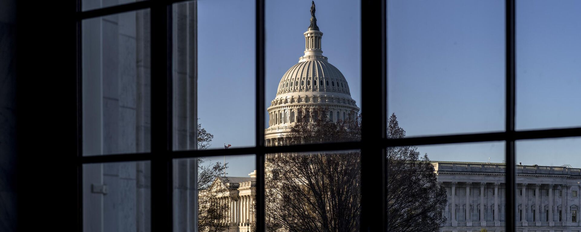 The U.S. Capitol is seen through a window in the Russell Senate Office Building in Washington, March 15, 2023.  - Sputnik भारत, 1920, 07.12.2023