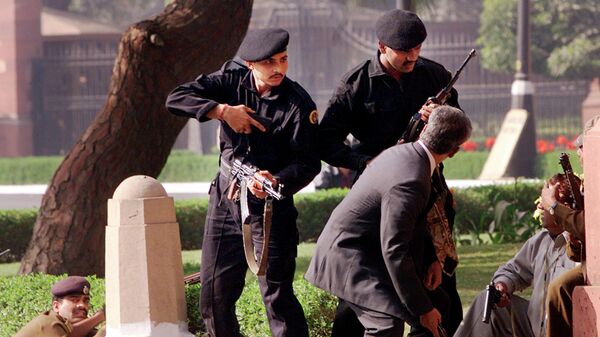 FILE - In this Dec. 13, 2001, file photo, Indian commandoes escort civilians outside the Parliament after gunmen attack in New Delhi, India - Sputnik India
