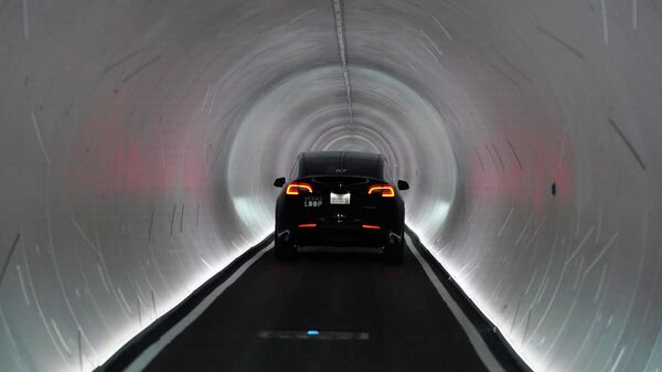 A Tesla car drives through a tunnel in the Las Vegas Convention Center Loop, an underground tunnel developed by Elon Musk's The Boring Company, Tuesday, June 8, 2021, in Las Vegas. - Sputnik India