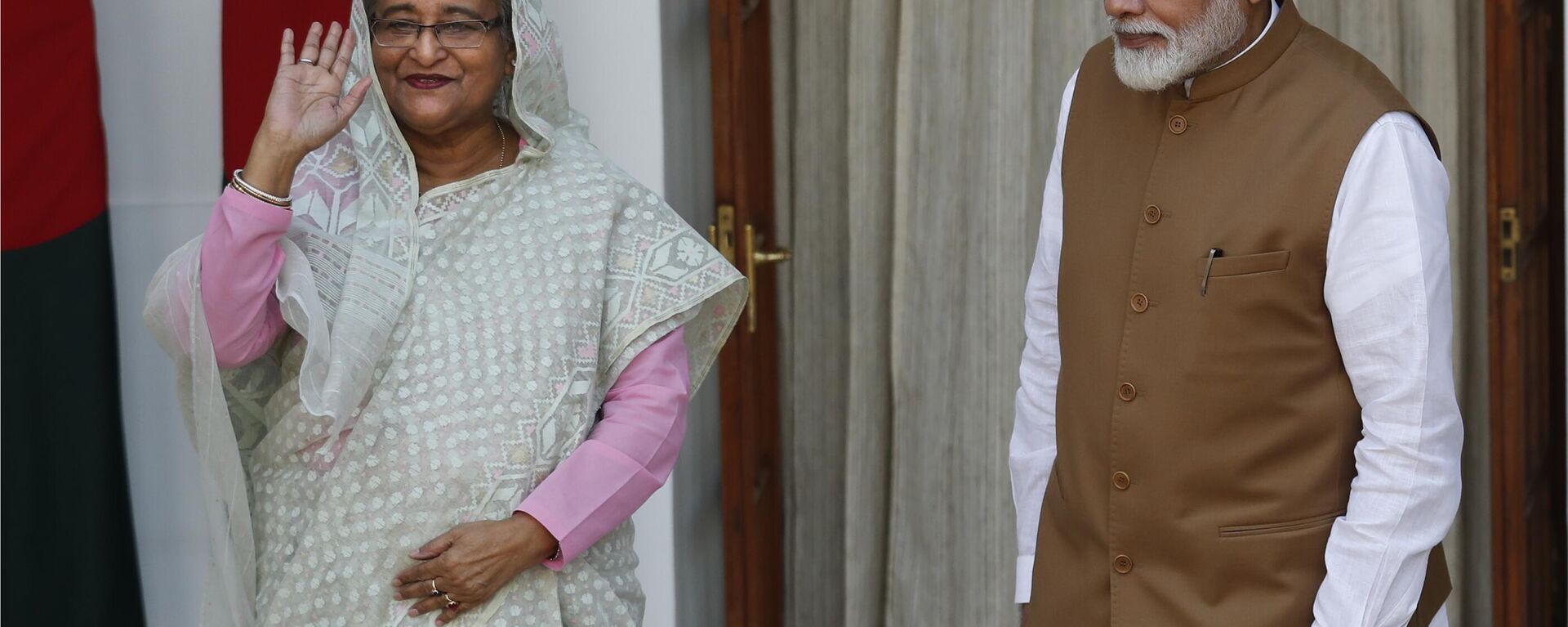 Indian Prime Minister Narendra Modi, right, watches his Bangladeshi counterpart Sheikh Hasina wave to the media before their meeting in New Delhi, India, Saturday, Oct. 5, 2019. - Sputnik India, 1920, 08.02.2024