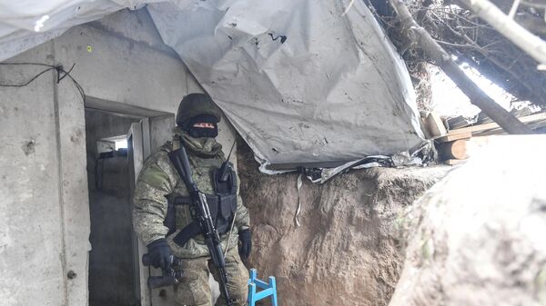 A Russian serviceman leaves a bunker in a trench at a position in the special military operation zone - Sputnik भारत