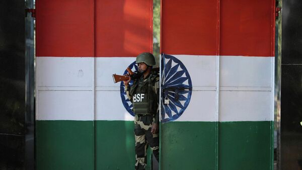 In this  Jan. 23, 2020, file photo, an Indian Border Security Force soldier walks through a gate painted with the Indian flag at the India-Pakistan border at Suchet Garh in Ranbir Singh Pura, about 27 kilometers (17 miles) south of Jammu, India. - Sputnik भारत