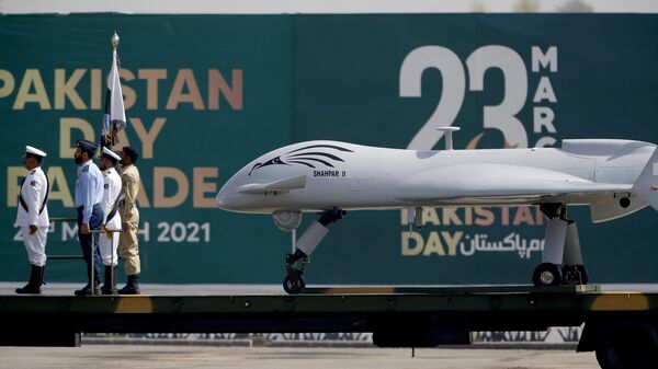 Pakistani soldiers stand beside a drone aircraft loaded on a trailer during a military parade celebrating Pakistan National Day, in Islamabad, Pakistan, Thursday, March 25, 2021. - Sputnik India