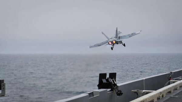 In this Wednesday, April 15, 2015 image released by U.S. Navy Media Content Services, an F/A-18E Super Hornet, assigned to the Knighthawks of Strike Fighter Attack Squadron 136, launches off the flight deck aboard Nimitz-class aircraft carrier USS Theodore Roosevelt in the Fifth Fleet area of operations - Sputnik भारत