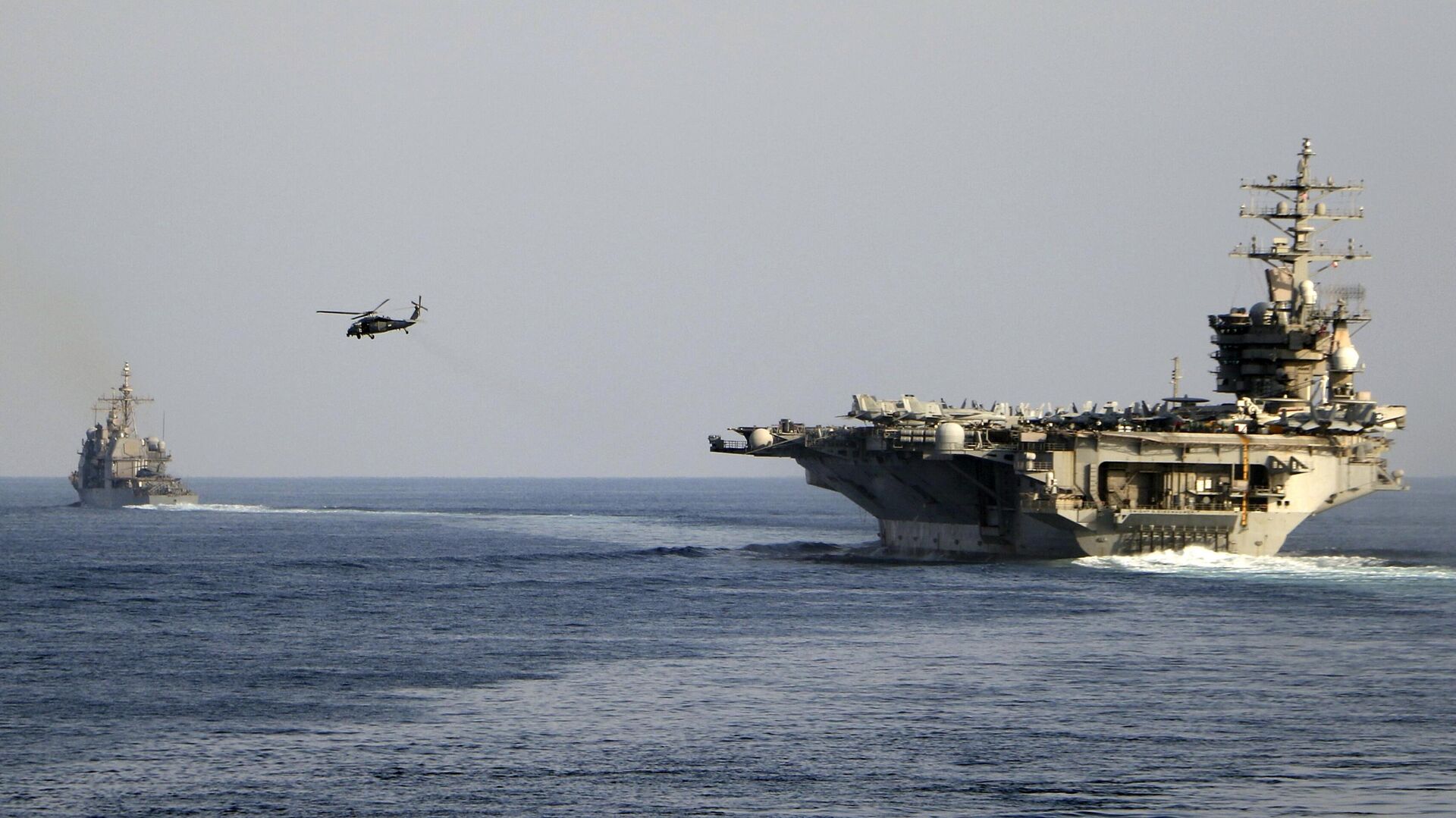 The aircraft carrier USS Dwight D. Eisenhower and other warships crosses the Strait of Hormuz into the Persian Gulf on Sunday, Nov. 26, 2023, as part of a wider American deployment in the Middle East amid the Israel-Hamas war. - Sputnik India, 1920, 20.01.2024