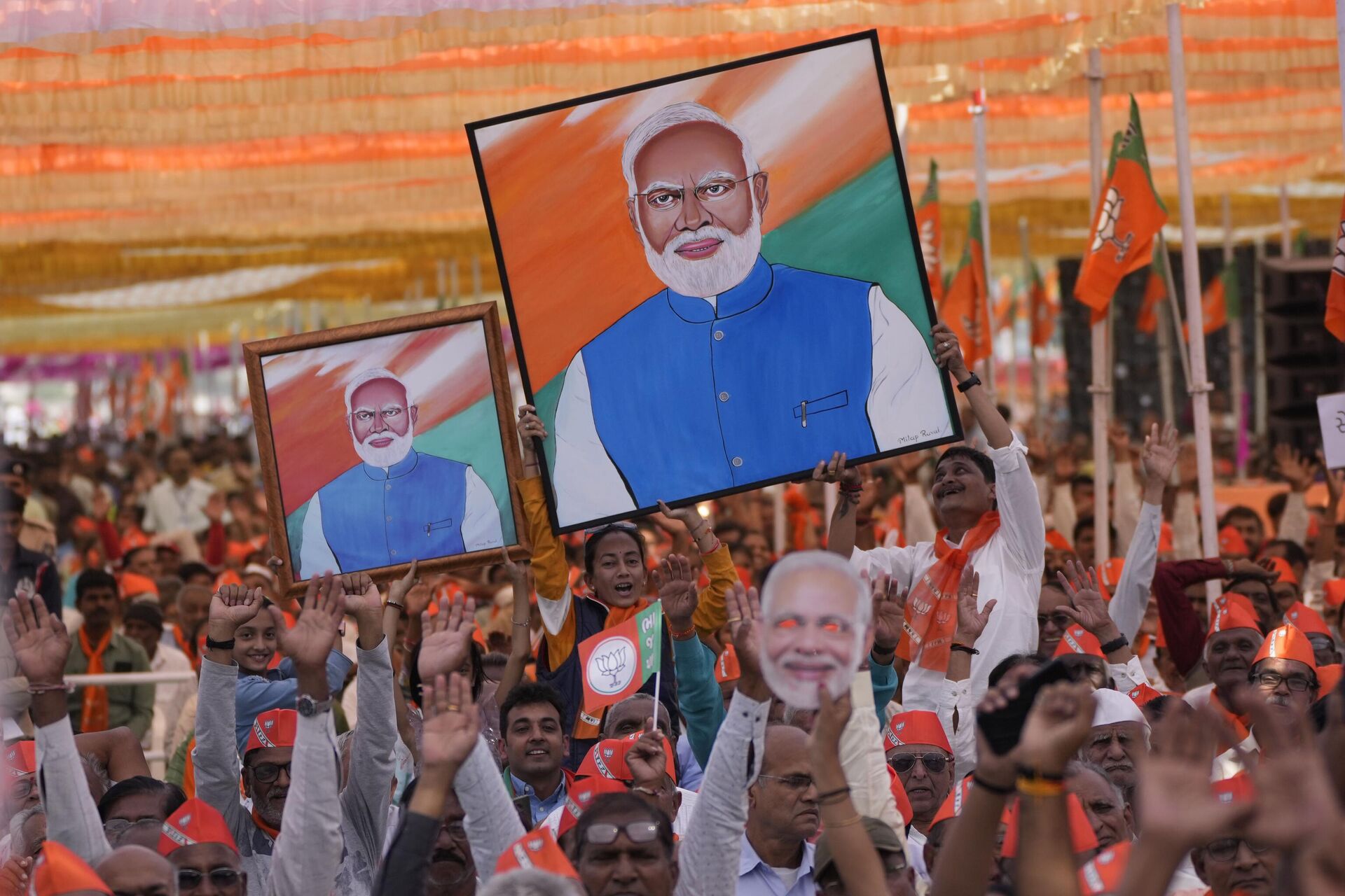 Supporters of India's ruling Bharatiya Janata Party(BJP) hold portraits of Prime Minister Narendra Modi during a public meeting ahead of the upcoming Gujarat state assembly elections in Mehsana, India, Wednesday, Nov. 23, 2022.  - Sputnik India, 1920, 17.02.2024