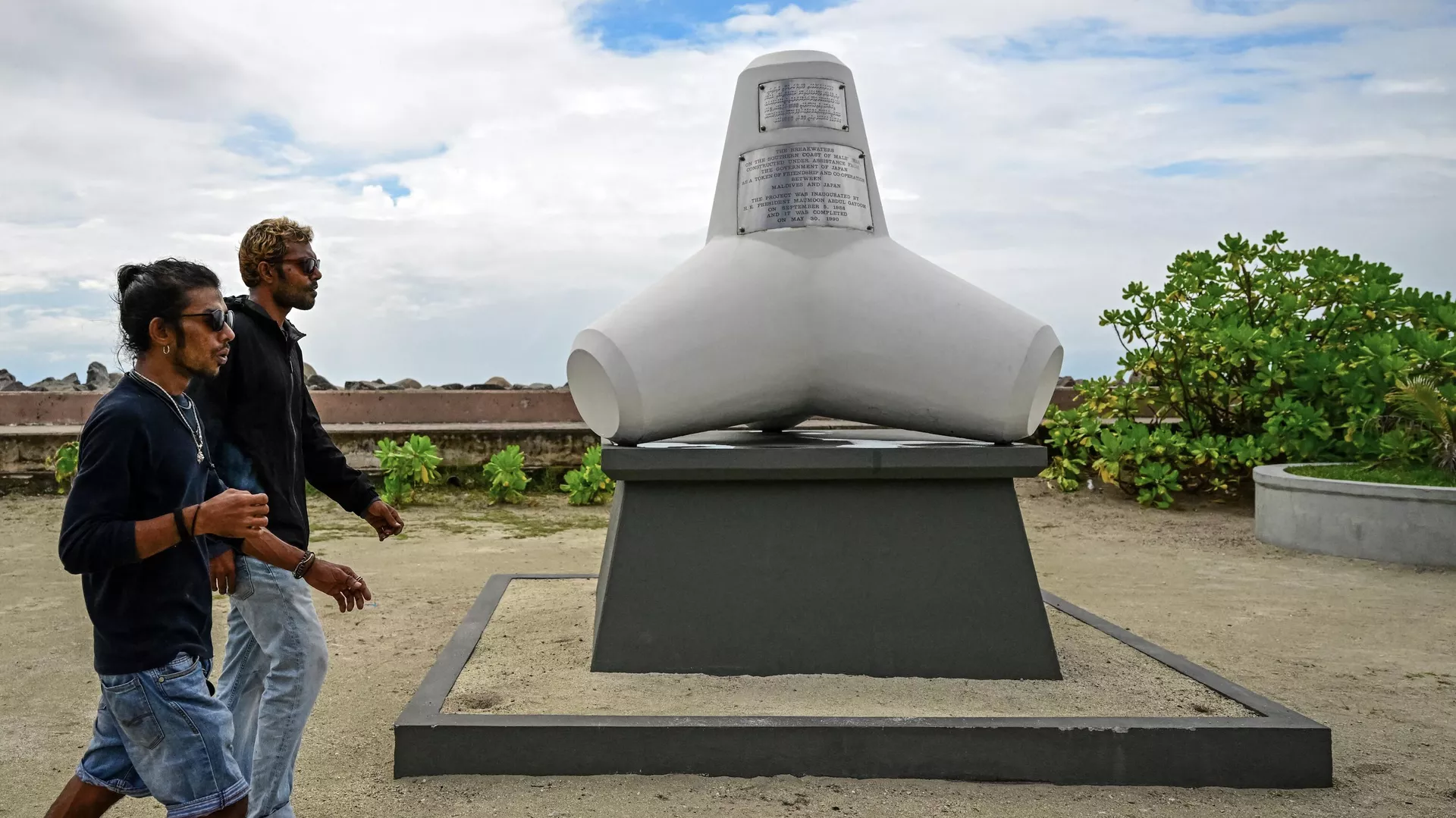 People walk past a life-size tetrapod in Male on November 18, 2023.