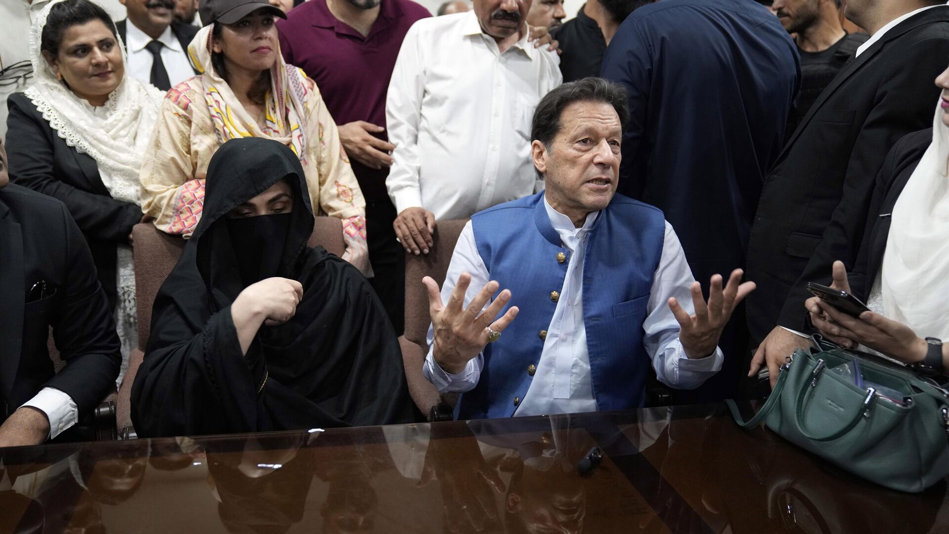 Pakistan's former Prime Minister Imran Khan, right, and Bushra Bibi his wife, talk to the media before signing documents to submit surety bond over his bails in different cases, at an office of Lahore High Court in Lahore, Pakistan, Monday, July 17, 2023. - Sputnik India, 1920, 08.02.2024