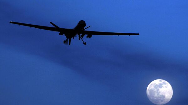 In this Jan. 31, 2010 file photo, an unmanned U.S. Predator drone flies over Kandahar Air Field, southern Afghanistan, on a moon-lit night.  - Sputnik भारत