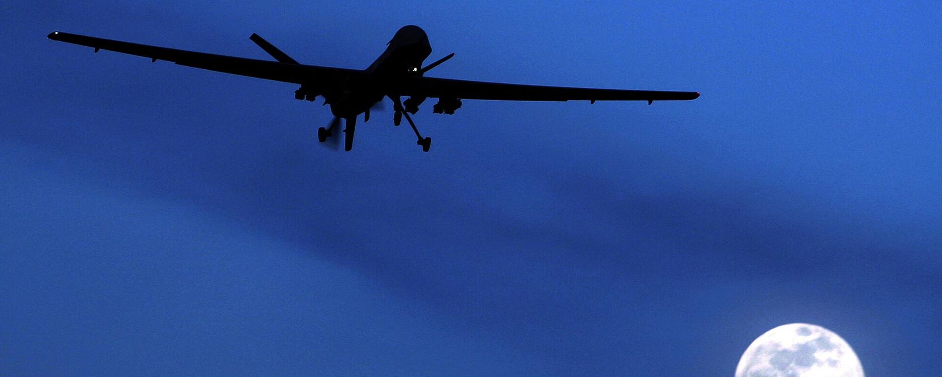 In this Jan. 31, 2010 file photo, an unmanned U.S. Predator drone flies over Kandahar Air Field, southern Afghanistan, on a moon-lit night.  - Sputnik भारत, 1920, 01.02.2024