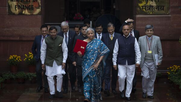Indian Finance Minister Nirmala Sitharaman, center, holding a pouch containing a digital tablet, leaves her office along with her colleagues for President's house before presenting the federal budget in the Parliament in New Delhi, India, Thursday, Feb. 1, 2024. (AP Photo/Altaf Qadri) - Sputnik India