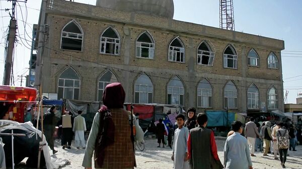 This frame grab image from video, shows a Taliban fighter standing guard outside the site of a bomb explosion inside a mosque, in Mazar-e-Sharif province, Afghanistan, Thursday, April 21, 2022. - Sputnik India