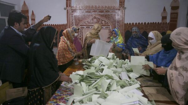 Members of polling staff count the votes after the polls closed for parliamentary elections, in Peshawar, Pakistan, Thursday, Feb. 8, 2024. - Sputnik India
