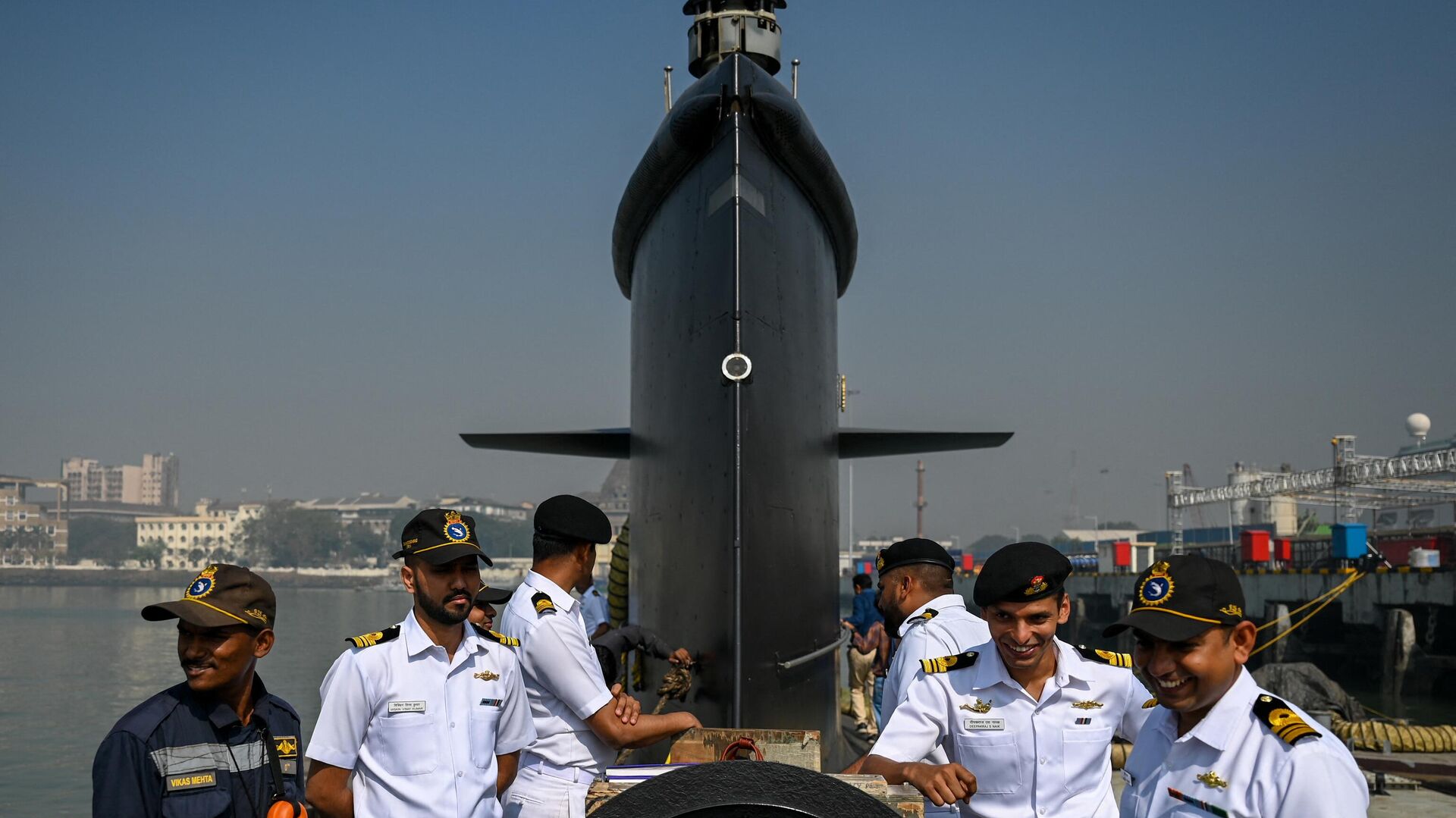 Indian navy officers interact on the deck of fifth Kalvari-Class submarine 'Vagir' anchored at the naval base ahead of its commissioning ceremony in Mumbai January 20, 2023. - Sputnik India, 1920, 09.02.2024