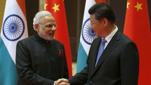 Indian Prime Minister Narendra Modi, left, and Chinese President Xi Jinping shake hands prior to their meeting in Xian, Shaanxi province, China, Thursday, May 14, 2015. - Sputnik भारत