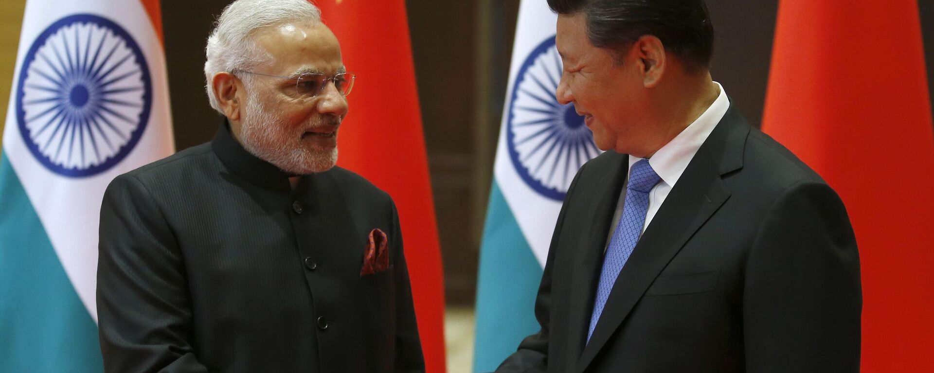 Indian Prime Minister Narendra Modi, left, and Chinese President Xi Jinping shake hands prior to their meeting in Xian, Shaanxi province, China, Thursday, May 14, 2015. - Sputnik India, 1920, 20.08.2025