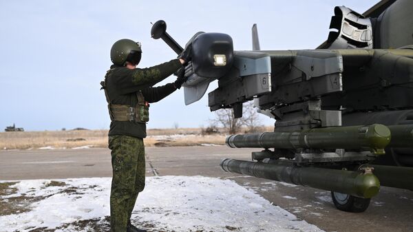 A serviceman of the Centr combat group of the Russian Armed Forces prepares a Ka-52 reconnaissance and attack helicopter for a flight in the zone of a special military operation. - Sputnik India