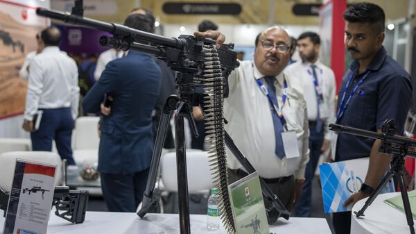 An exhibitor from Advanced Weapons And Equipment India Limited explains the working of a Light Machine Gun to a delegate at the International Police Expo 2023 in New Delhi, India, Wednesday, July, 26, 2023.  - Sputnik भारत