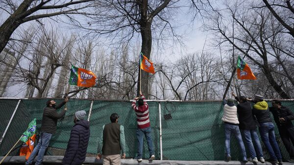 Activists from India's ruling Bharatiya Janata Party (BJP) party display party flags ahead of Indian Prime Minister Narendra Modi's visit to Srinagar, Indian-controlled Kashmir, Wednesday, March 6, 2024. - Sputnik India