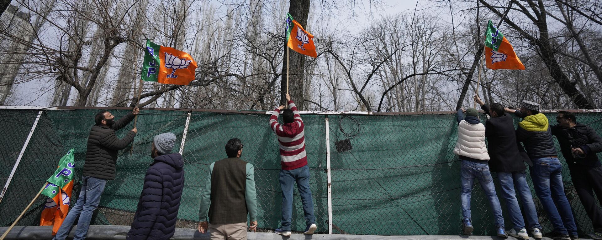 Activists of India's ruling Bharatiya Janata Party (BJP) party display party flags ahead of the Indian Prime Minister Narendra Modi's visit to Srinagar, Indian controlled Kashmir, Wednesday, March 6, 2024. - Sputnik India, 1920, 12.04.2024
