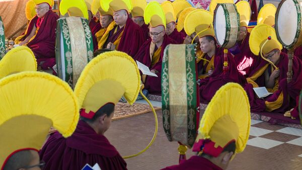 Exile Tibetan Buddhist monks wearing yellow hats of the Gelug school of the Tibetan Buddhism pray during an early morning session to mark the first day of the Tibetan new year at the Tsuglakhang temple in Dharamshala, India, Saturday, Feb. 10, 2024. - Sputnik India