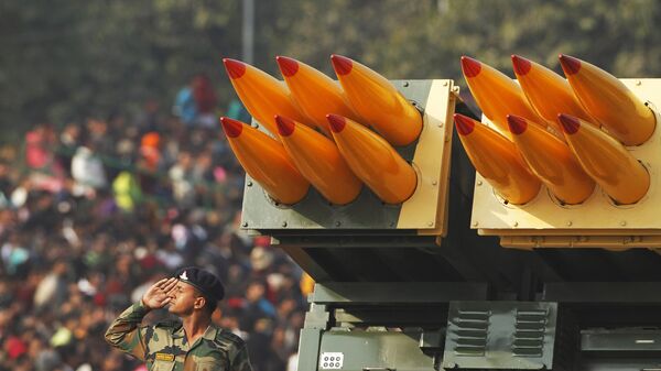 In this Jan. 26, 2011 file photo, an Indian army soldier salutes beside a Pinaka multiple rocket launcher at the Republic Day parade in New Delhi, India. In its race to join the club of international powers, India has reached another major milestone, it's now the world's largest weapons importer.  - Sputnik भारत