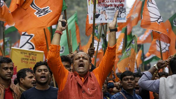 Supporters of India's ruling Bharatiya Janata party (BJP) shout slogans, during a rally supporting the implementation of Citizenship Amendment Act (CAA) and National Register of Citizenship (NRC), in Kolkata, India, Monday, Dec. 23, 2019. - Sputnik India