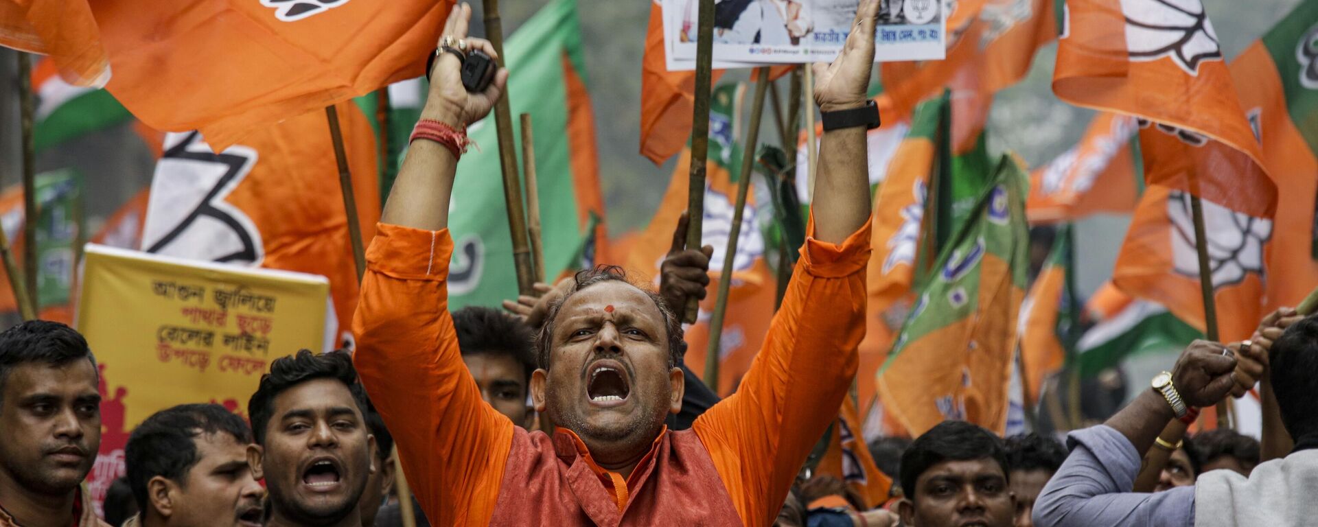 Supporters of India's ruling Bharatiya Janata party (BJP) shout slogans, during a rally supporting the implementation of Citizenship Amendment Act (CAA) and National Register of Citizenship (NRC), in Kolkata, India, Monday, Dec. 23, 2019. - Sputnik भारत, 1920, 12.03.2024
