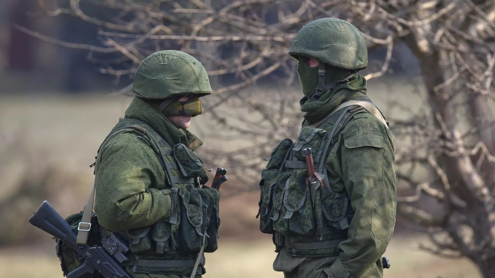 Pro-Russian soldiers stands outside the Ukrainian infantry base in Perevalne, Ukraine, Wednesday, March 12, 2014