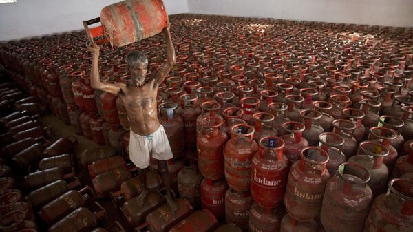 FILE- In this Aug.1, 2016 file photo, an Indian laborer sorts liquefied petroleum gas (LPG) cylinders used for cooking at a warehouse after downloading them from a truck in Allahabad, India.  India has become the world's second largest importer of liquefied petroleum gas as its government pushes cleaner alternatives to traditional cooking fuels such as firewood and cow dung. (AP Photo/Rajesh Kumar Singh, File) - Sputnik India