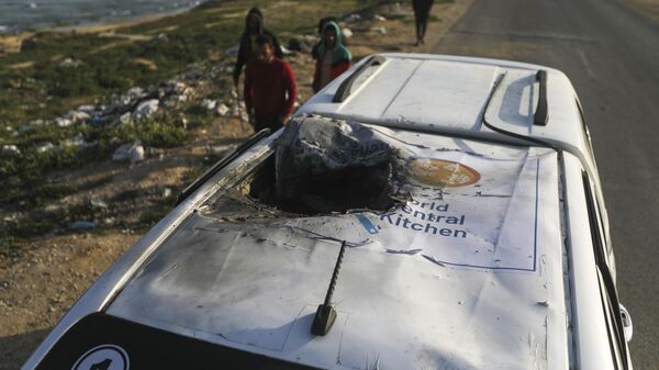 Palestinians inspect a vehicle with the logo of the World Central Kitchen wrecked by an Israeli airstrike in Deir al Balah, Gaza Strip, Tuesday, April 2, 2024. A series of airstrikes killed seven aid workers from the international charity, leading it to suspend delivery Tuesday of vital food aid to Gaza. - Sputnik भारत