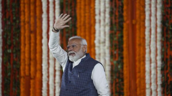 Indian Prime Minister Narendra Modi waves at a public rally at the Moulana Azad Stadium during which he inaugurated several projects in Jammu and Kashmir, in Jammu, India, Tuesday, Feb. 20, 2024. - Sputnik India