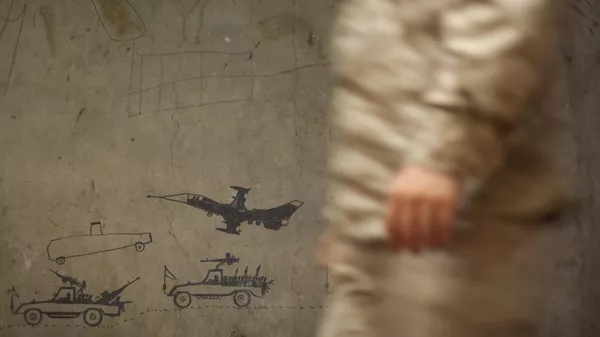 A US military passes by a wall caovered with military graffiti - Sputnik भारत
