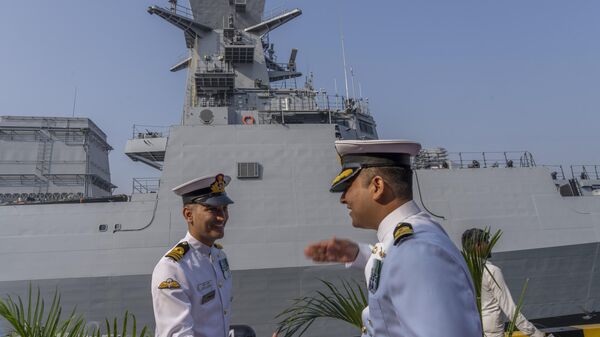 Indian navy officers greets each other during the commissioning ceremony of INS Mormugao, the stealth guided-missile destroyer ship at a naval dockyard in Mumbai, India, Sunday, Dec. 18, 2022.  - Sputnik भारत