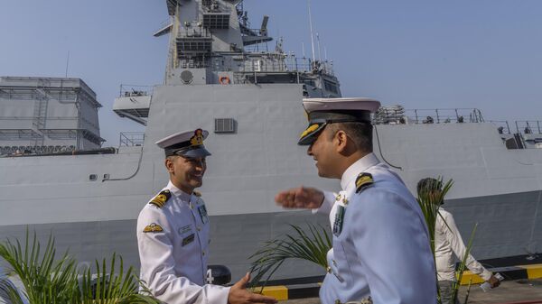 Indian navy officers greets each other during the commissioning ceremony of INS Mormugao, the stealth guided-missile destroyer ship at a naval dockyard in Mumbai, India, Sunday, Dec. 18, 2022.  - Sputnik India