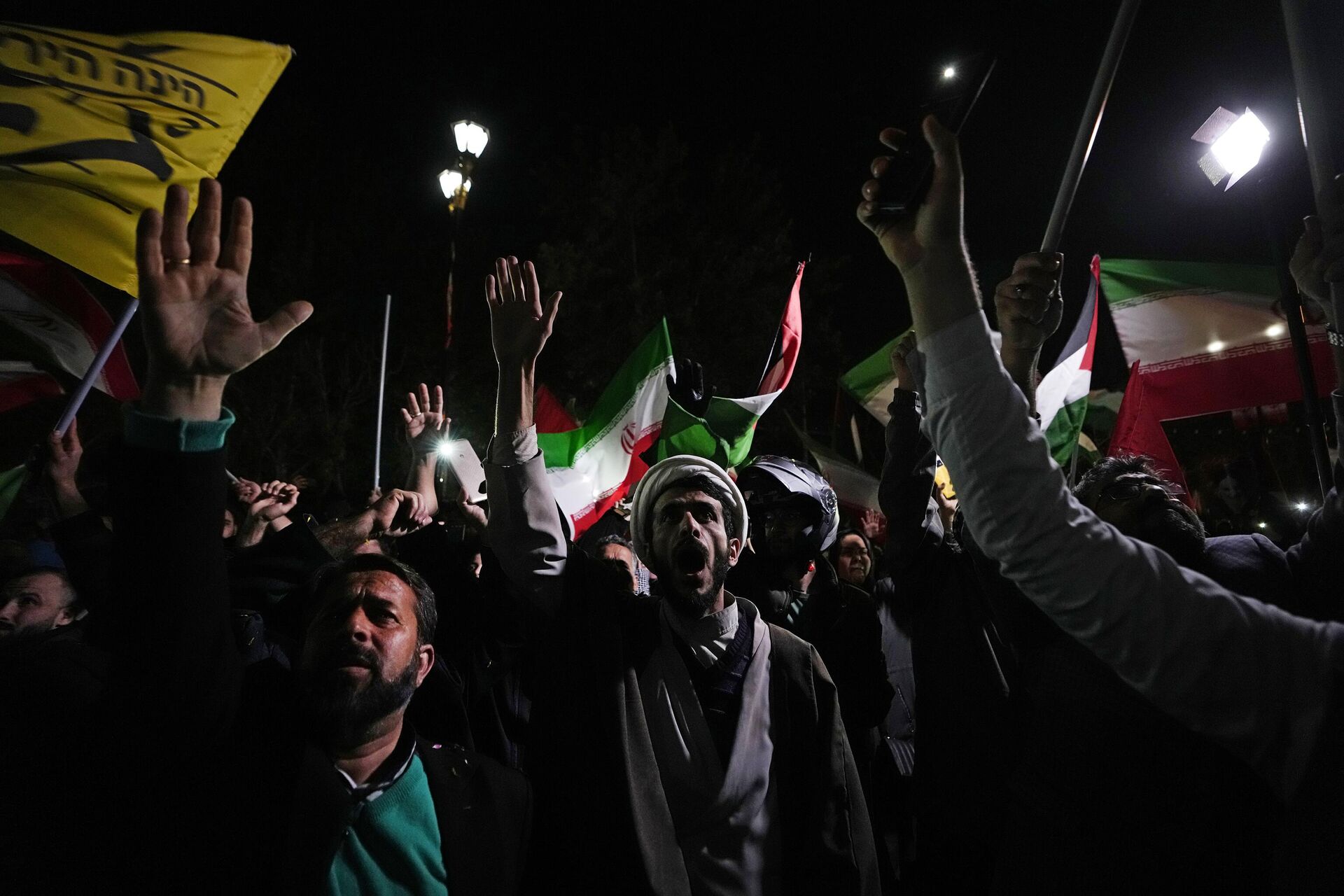 Iranian demonstrators chant slogans during an anti-Israeli gathering in front of the British Embassy in Tehran, Iran, early Sunday, April 14, 2024. Iran launched its first direct military attack against Israel on Saturday. - Sputnik भारत, 1920, 15.04.2024