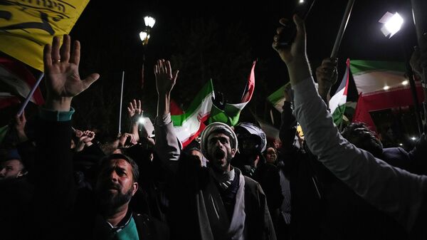 Iranian demonstrators chant slogans during an anti-Israeli gathering in front of the British Embassy in Tehran, Iran, early Sunday, April 14, 2024. Iran launched its first direct military attack against Israel on Saturday. - Sputnik India