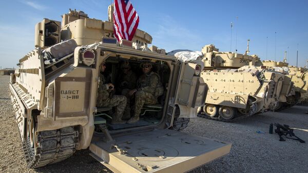 Crewmen sit inside Bradley fighting vehicles at a US military base at an undisclosed location in Northeastern Syria, Monday, Nov. 11, 2019. - Sputnik India