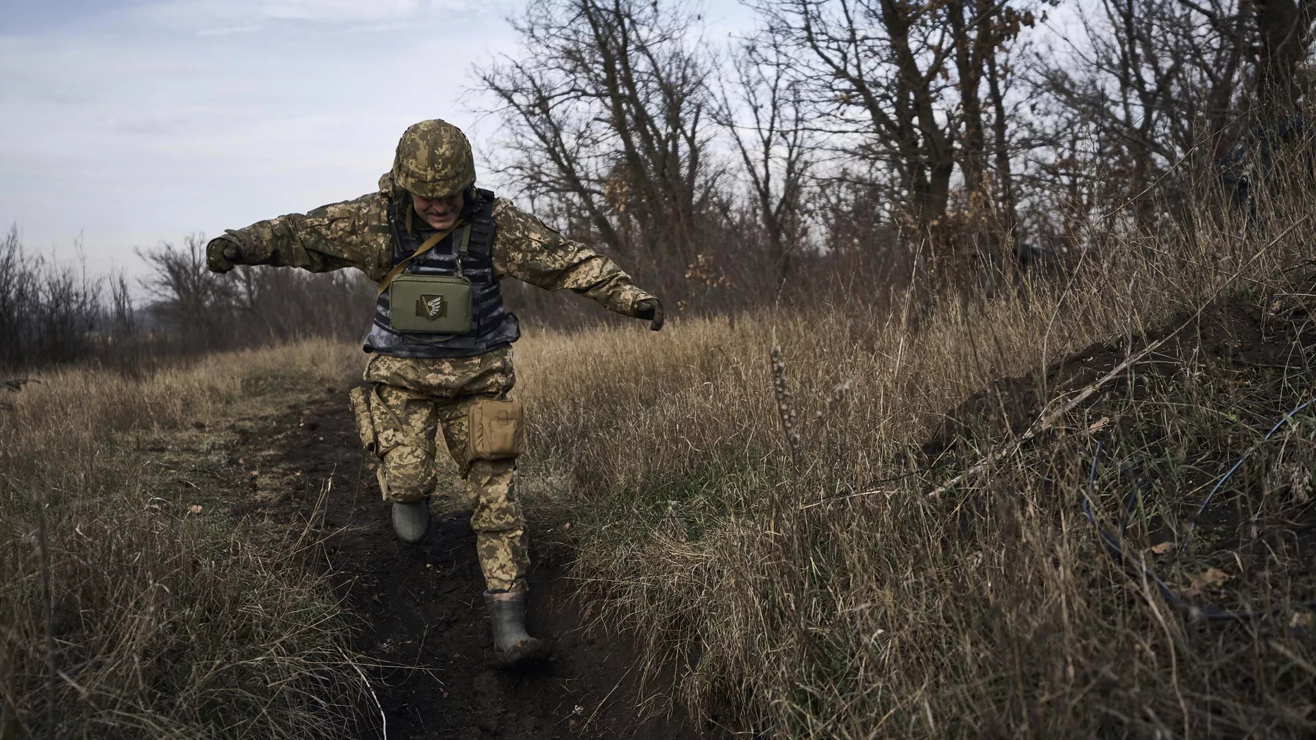 A Ukrainian soldier runs for cover during fights with Russian forces near Maryinka, Ukraine, Friday, Dec. 23, 2022.
