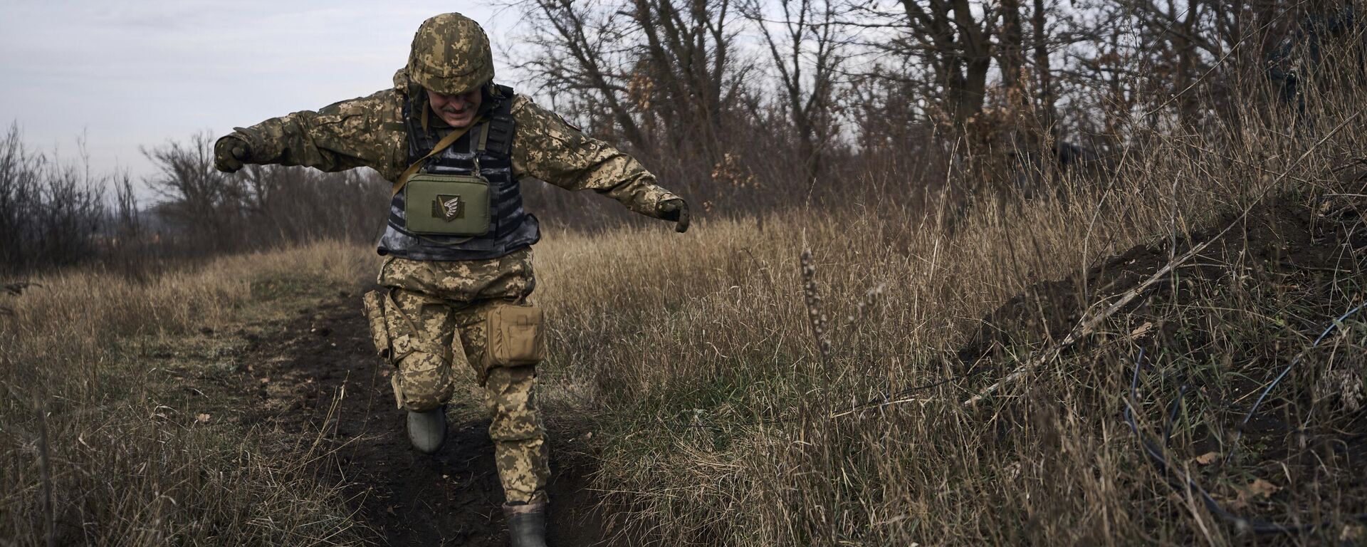 A Ukrainian soldier runs for cover during fights with Russian forces near Maryinka, Ukraine, Friday, Dec. 23, 2022. - Sputnik भारत, 1920, 25.04.2024