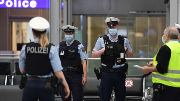 Police officers wearing face masks stand at the Duesseldorf airport, western Germany, on June 15, 2020 - Sputnik India
