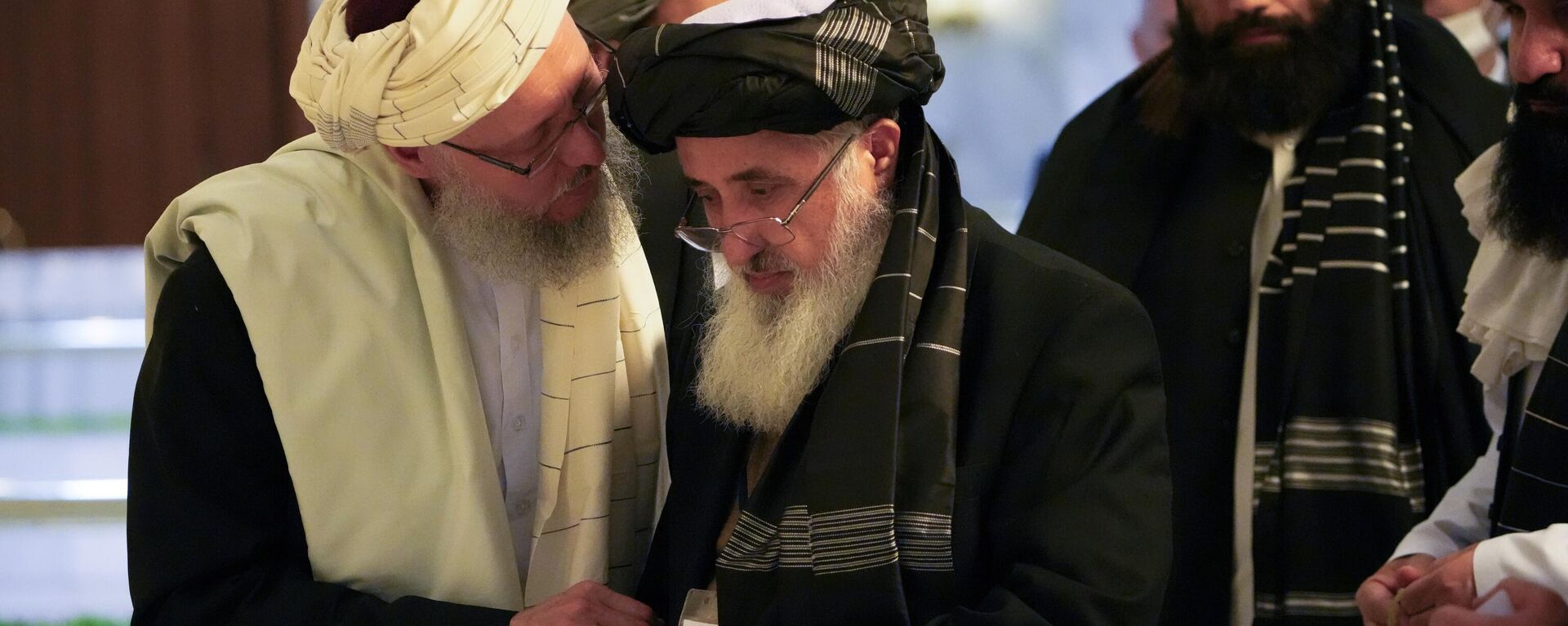 Abdul Salam Hanafi, a deputy prime minister in the Taliban's interim government, left, speaks with acting Foreign Minister of Afghanistan, Taliban official Amir Khan Muttaqi during talks involving Afghan representatives in Moscow, Russia, Wednesday, Oct. 20, 2021. - Sputnik भारत, 1920, 27.05.2024